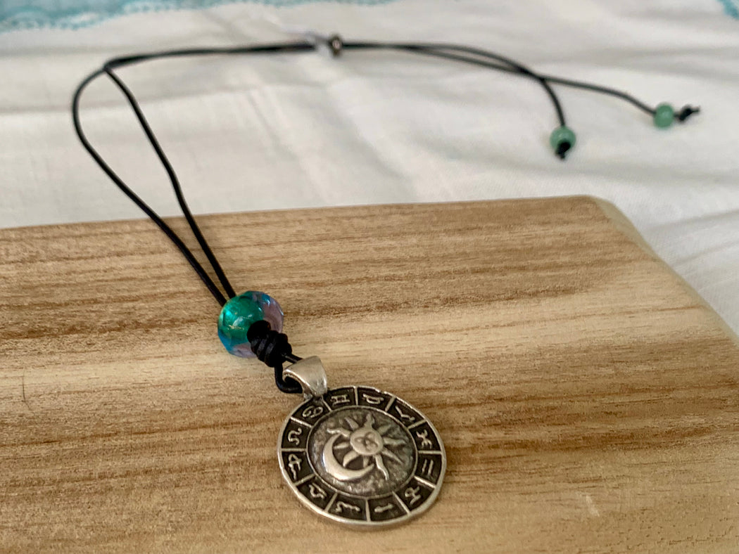 astrological pendant on adjustable leather cord
