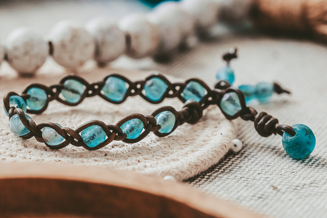 Aqua Ghana glass beads braided on leather for a bracelet