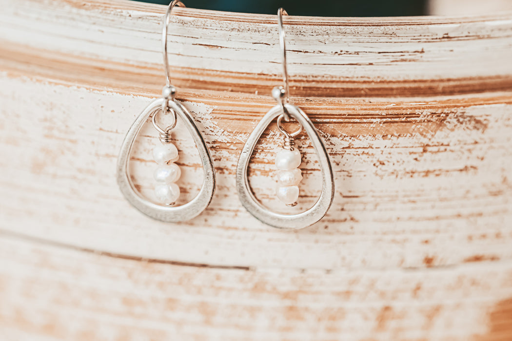 silver hoop earrings with tiny pearls inside